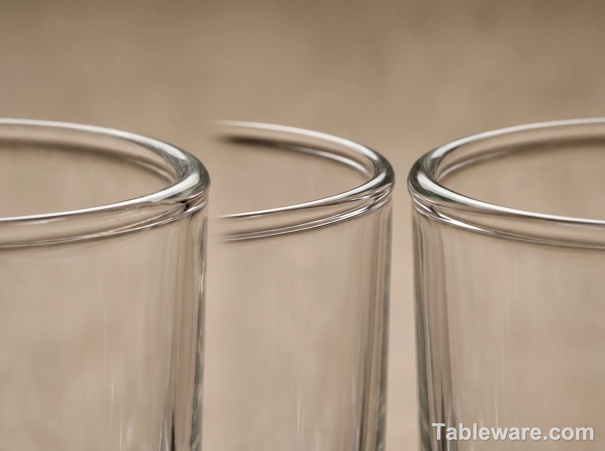Macro close-up of three glass rims: Anchor Hocking Central Park (left, cut-and-polished), Libbey Polaris (middle, cut-and-polished), Crate & Barrel Bodega (right, fire-polished)